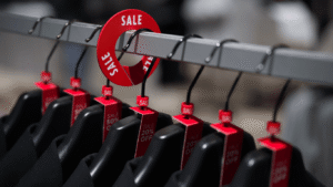 Size tags for hangers with sale message in a store