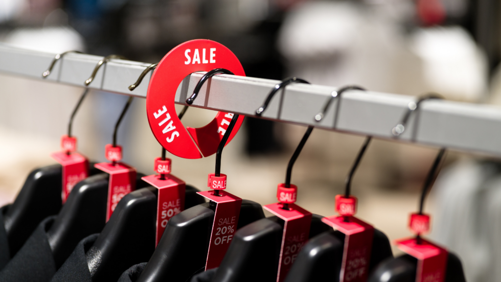 A rack with clothes with size markers, size labels and rack dividers